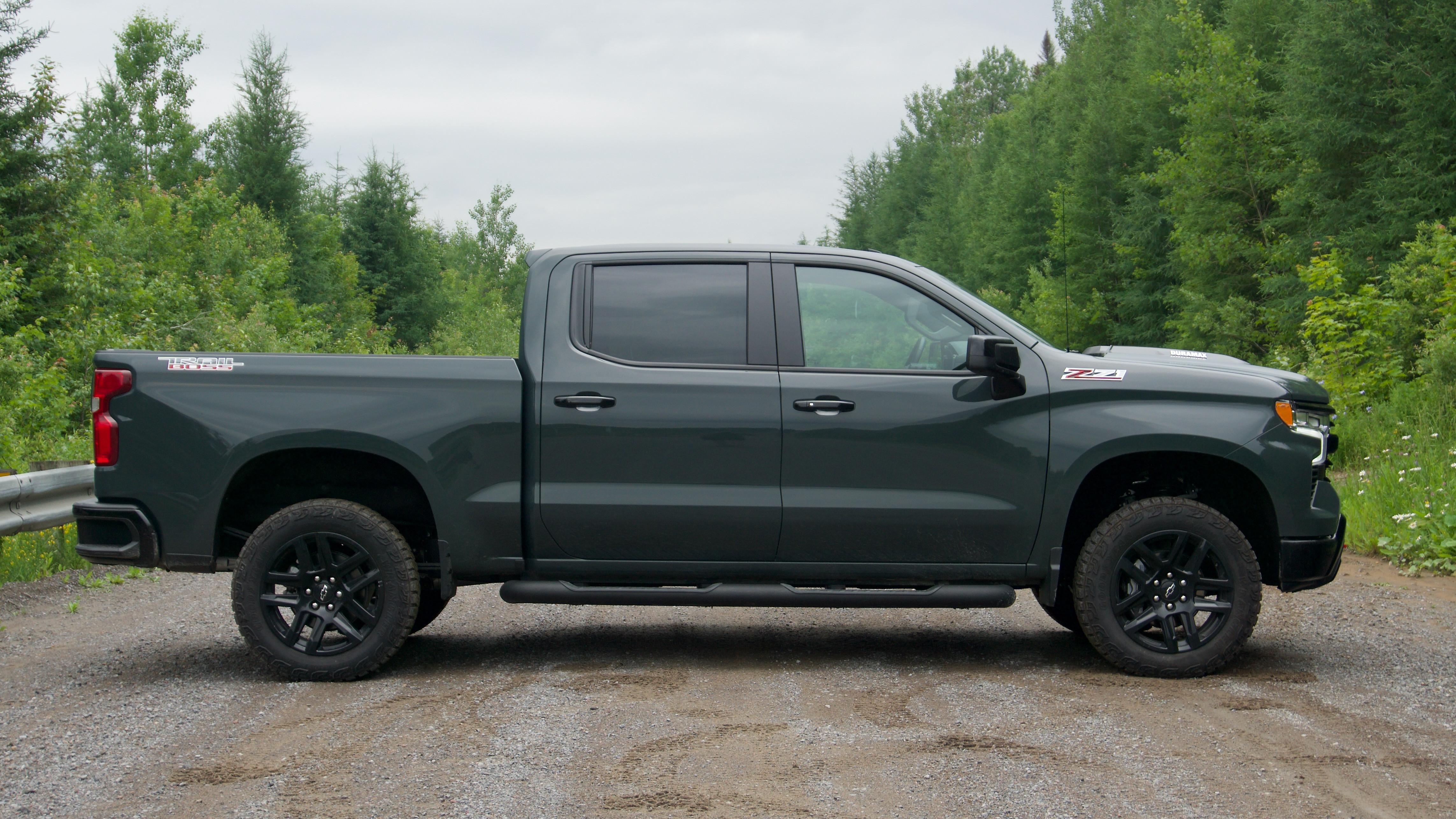 Chevrolet Silverado 1500 crew cab parked on a gravel road with the front tire and wheel visible