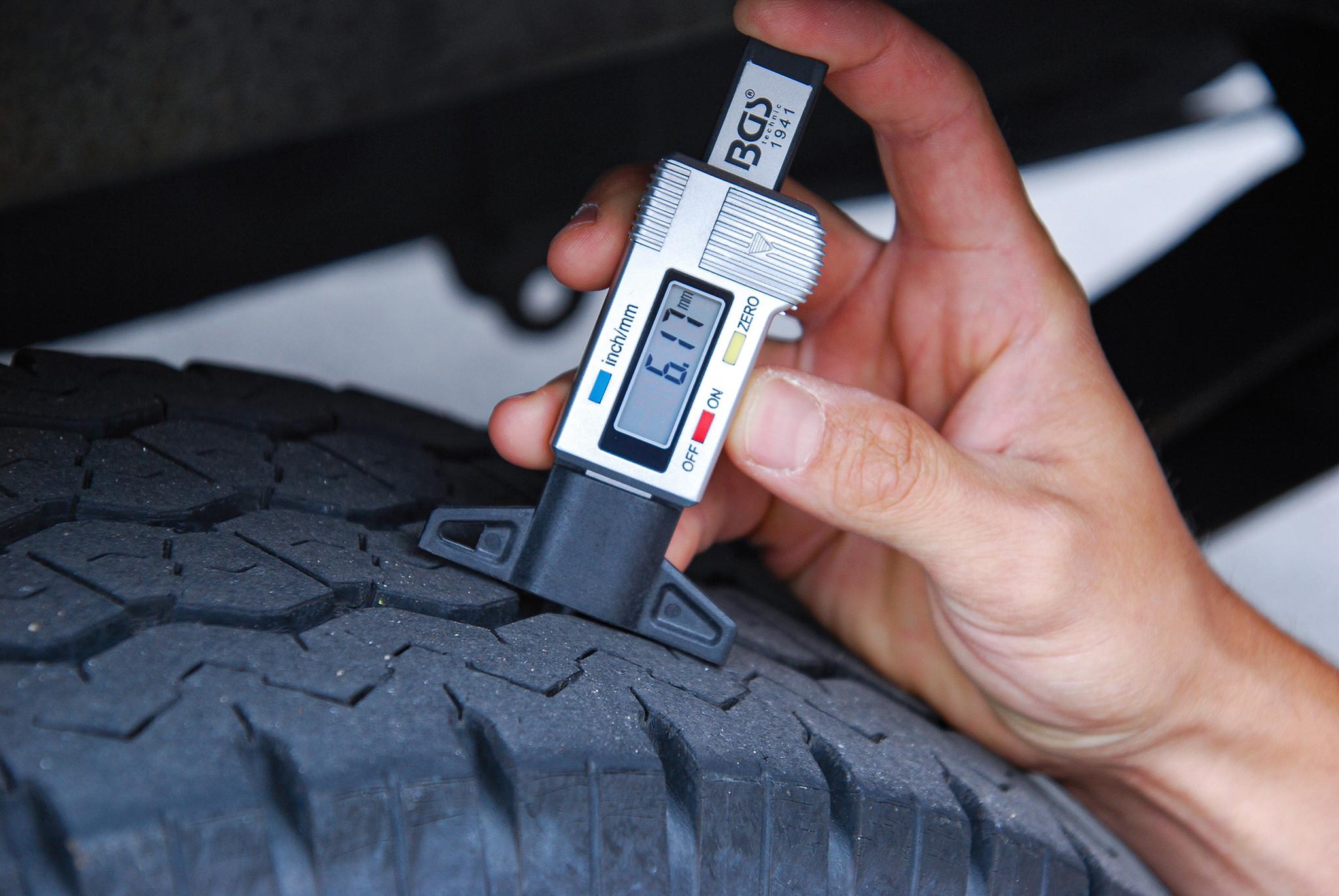 Tire tread depth gauge measuring remaining tread