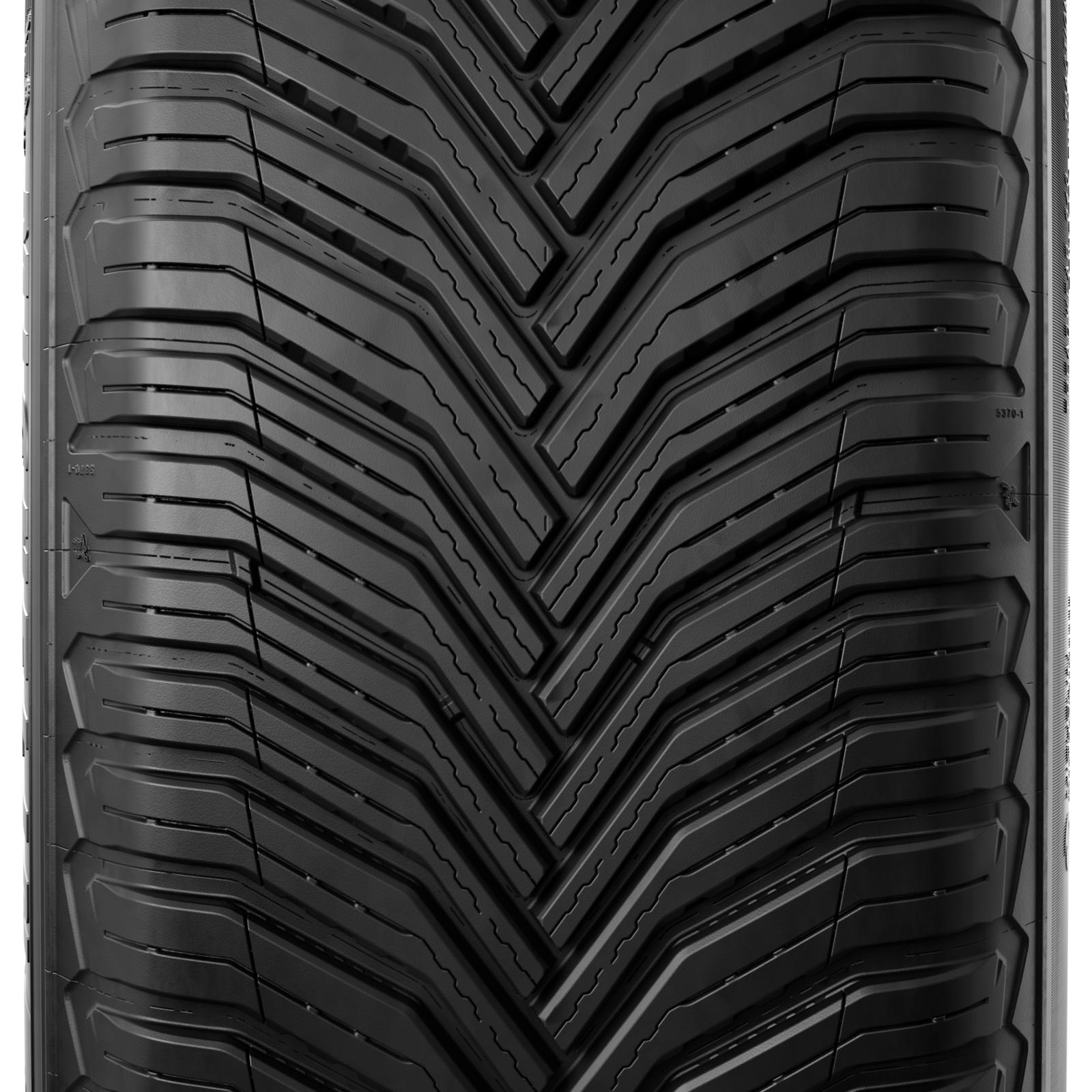 Michelin CrossClimate 2 V-shaped tread blocks with a snowflake symbol, photographed on a wet road