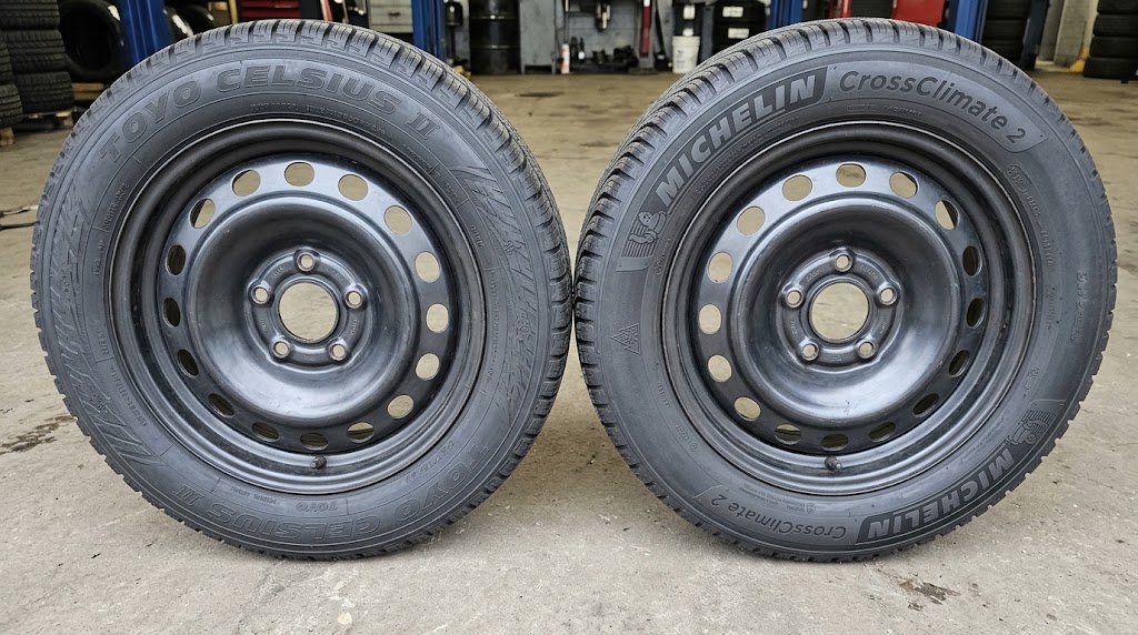 Toyo Celsius II and Michelin CrossClimate 2 tires standing side by side, both showing the three-peak mountain snowflake on the sidewall